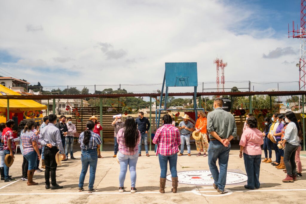 A circle of people meeting to discuss issues during a nonprofit gathering